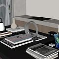 Modern Black Table with Magazines Lamp Pen Holder and Daily Items by Large Windows with Green Plants