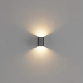 Modern Black Wall Lamp Mounted on Gray Wall Illuminating Warm Light With Sleek Contemporary Design