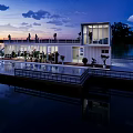 Waterfront Container Building With Staircase Wooden Platform And Small Boat On Lake