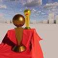 Decorative Ornament Set With Gold Silver Trophies On Red Draped Platform Against Blue Sky