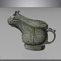 Ancient Bronze Household Utensil With Animal Head Design And Intricate Patterns