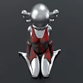 Detailed Metallic Doll With Silver Head Red Accents And Kneeling Pose