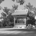 Chinese Traditional Pavilion With Black Roof Red Pillars Surrounding Trees Rocks And Red Flowers