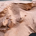 Natural Sandy Terrain With Weathered Wavy Rock Formations And Eroded Surface Features