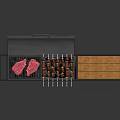 Outdoor Barbecue Grill With Meat Skewers And Orange Side Panel On Metal Stand