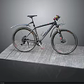 Mountain Bike With Fenders Displayed On Wooden Platform Against Black Background