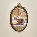 Oval Mirror with Gold and Black Ornate Frame Reflecting Bed and Striped Wall