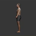 Shirtless Man Wearing Black Shorts Standing Barefoot Against Gray Background