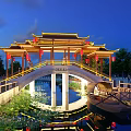 Chinese-style Bridge With Traditional Roof Red Lanterns Under Night Starry Sky And Water Reflection