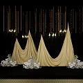Elegant Floral Installation with Golden Conical Drapes White Flowers and Hanging Decorations on Black Background