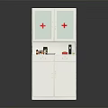White Medical Cabinet With Red Cross Glass Doors And Medicine Bottles On Top