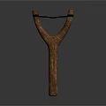 Wooden Y Shaped Slingshot With Black Rubber Band Isolated On Dark Background