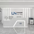 Modern Front Desk Reception Area With White Counter Lighting Office Equipment And Plants