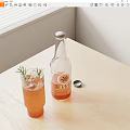 Bottle and Glass with Orange Drink Rosemary Lemon Slice on Light Wooden Table by Window