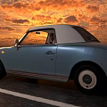 Light Blue Vintage Car with Lit Round Headlights Driving at Dusk with Two People Inside