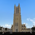 Historic European Architecture Tower With Stone Facade Plaza And People Under Blue Sky