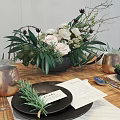 Elegant Tableware Set with Copper Mugs Black Plates Rosemary and Floral Arrangement on Wooden Table
