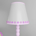 Pink Table Lamp with White Shade on Shelf with Books Colored Pencils and Alphabet Blocks