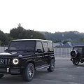Two Black SUV Cars With Front Grille Round Headlights In Outdoor Parking Lot