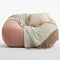 Cozy Pink Bean Bag Chair With Soft Beige Fringed Blanket And Cushion