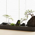 Mini Garden Ornament Featuring Black Rectangular Basin Stones Small Trees And White Blinds Background