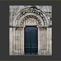 Ancient Stone Gate With Intricate Carvings And Green Wooden Doors