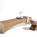 Curved Wooden Public Chair With Striped Design Featuring Geometric Stool Vase Dried Flowers And Blanket