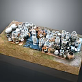 Various Ceramic Sculptures In Different Shapes Sizes Arranged On Textured Display Platform With Earth Tones