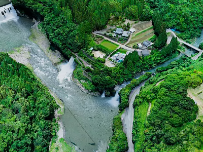Scenic Natural Landscape with Flowing River Cascading Waterfalls and Lush Green Forest Surrounding Small Village 3d model