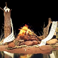 Burning Bonfire With Firewood Stones And Scrolls On Sandy Ground
