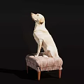 Yellow Reptile Lizard Sitting On Patterned Fabric Stool Against Dark Backdrop
