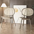 Modern Dining Chairs With Rattan Backrest And Wooden Legs In Interior With Abstract Painting