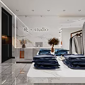 Modern Clothing Store Interior With Folded Blue Clothes Hanging Garments And Marble Countertop