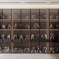 Modern Display Cabinet With Glass Doors And Robot Models On Multiple Shelves With Interior Lighting