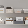 Storage Baskets And Boxes In Various Colors On Shelves For Home Organization