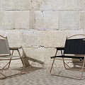 Two Foldable Leisure Chairs With Gray And Black Fabric Metal Frame Stone Wall Background