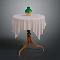 Round Wooden Table With White Fringed Tablecloth And Green Beige Vase