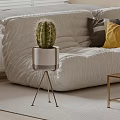 Cactus Bonsai Plant In White Pot With Gold Stand Near White Sofa And Colorful Pillows