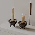 Modern Minimalist Candle Holders with Black Tripod Base and White Candles on White Table