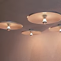 Three Modern Wall Lamps On Wall With Round Shades And Visible Light Bulbs