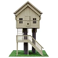 Wooden Tree House Built On Two Trees Featuring Staircase Balcony And Sloped Roof