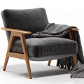 Stylish Gray Velvet Armchair With Wooden Armrests And Black White Striped Blanket Fringe