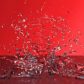 Red Garden Ornament Vase With Splashing Water On Red Background