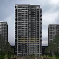 Modern High Rise Residential Building With Glass Windows And Evening Lighting