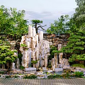 Natural Garden Ornament with Rock Formations Pond Water Lilies and Lush Greenery