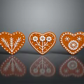 Heart Shaped Gingerbread Cookies Decorated With White Icing And Floral Patterns