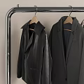 Clothes Rack with Hanging Coats Black Dresser Lamp and Sign in Modern Room Interior