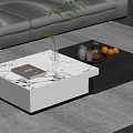 Modern Coffee Table with White and Dark Design Featuring Green Plant Book and Fruit Tray