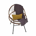 Modern Rattan Single Chair With Black Metal Legs Yellow Cushion And Purple Blanket