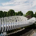 Scenic Wavy White Landscape Bridge Over Water With Reflection And Green Trees